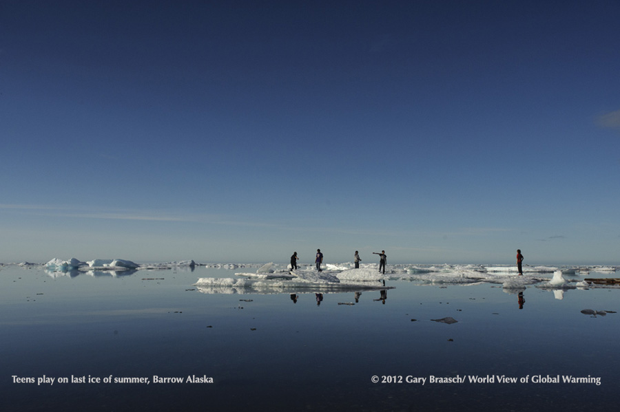 Barrow, Alaska, midnight sun view down street to nearly ice free Arctic Ocean, early Aug 2012, when sea ice reached record low.