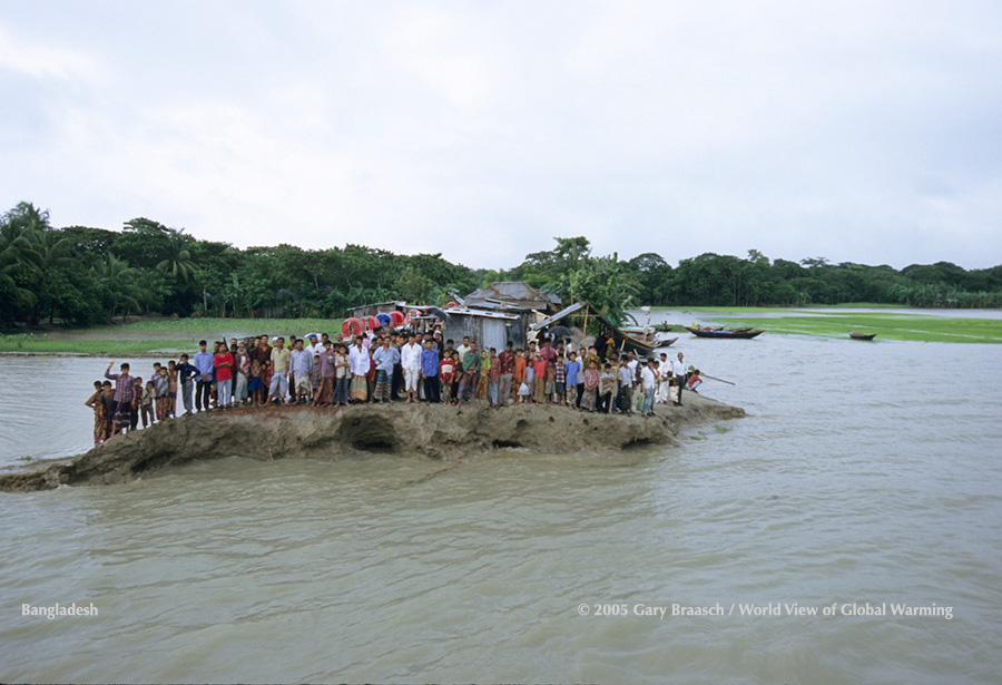 Bhola Island, Bangladesh, village in delta being eroded from tide influence; 87 people stand on road remnant.