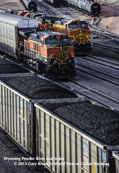 Powder River coal trains stage at Guernsey, Wyoming, with bitumin, another fossil product, in tank cars behind.