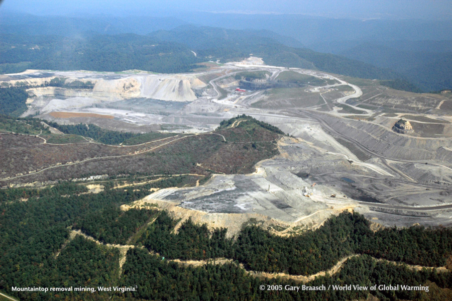 Mountaintop removal mining near Charleston WV, land abuse that blasts away entire forests, bulldozes overburden into streams and scrapes up coal with giant machines. Flight by Southwings.