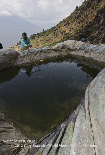 Farmer Mempayhelmo Tamang tends a new rainwater harvest pond, combating climate changes in village of Ramche, Nepal