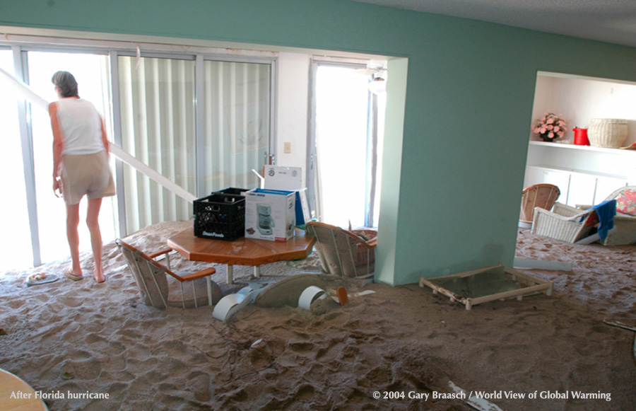 Women dejectedly surveys damage from hurricanes, Stuart, Florida.