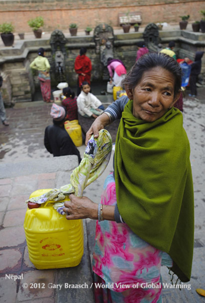 Like thousands of urban poor, a woman lugs water from the Manga Hiti spouts, in Patan Durbar Square, Nepal.